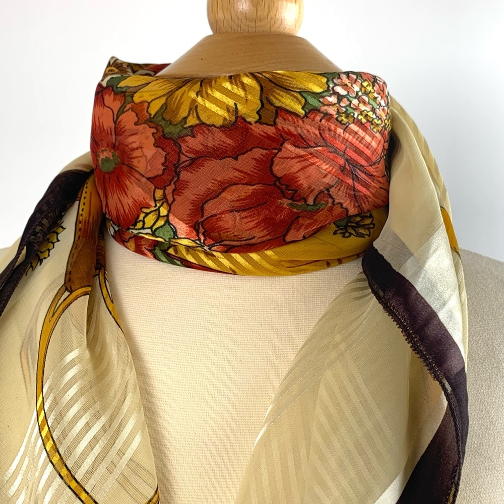 Lovely scarf with a hat and golden ribbons and a bouquet of flowers